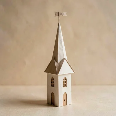 Papercraft story of a tall folded-paper church spire with a small paper-cut weat
