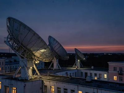 Radio dish array pointing at darkening eastern sky