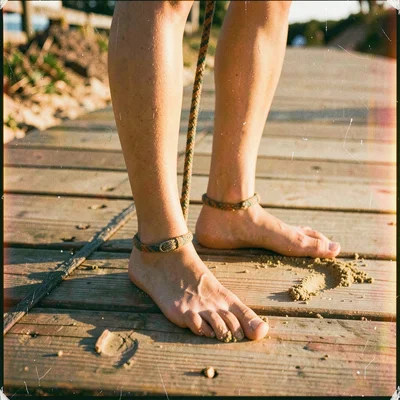 Sandy bare feet on warm boardwalk