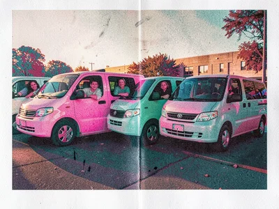 Identical minivans queued in a school pickup line with parents leaning out of wi