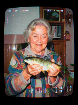 A grandmother holding up a fish she caught, the image warped by magnetic interfe