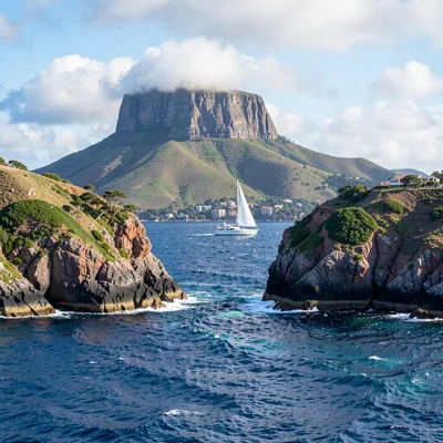 Cape Town mountain-sea duality, Table Mountain backdrop, yacht sailing between t