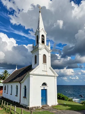 Sunday stillness in Nuku'alofa, Tonga, White church steeple against dramatic wha