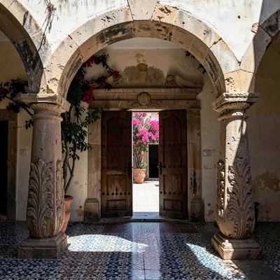 Iron-Studded Doors Ajar to Courtyard