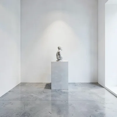 clean gallery interior with a polished concrete floor and a sculpture plinth
