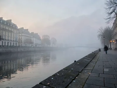 Empty quay in fog with one figure distant