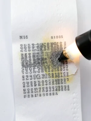 Strip of thermal paper deliberately heated with a lighter, gradient from pristin