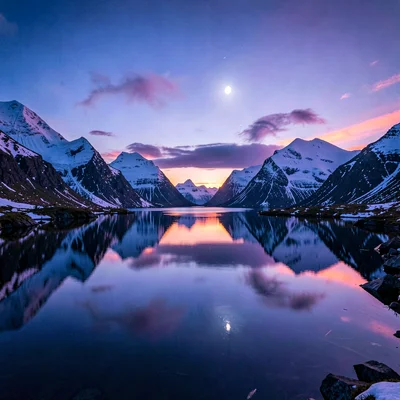 Polar liminal light, extended blue hours, Mountains reflected perfectly in a fjo