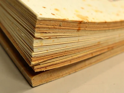 Paperback book edge, rough-cut pages creating irregular striation, some pages sl