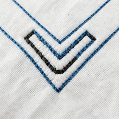 Corner motif detail — interlocking C and U forms meeting at right angle, white c