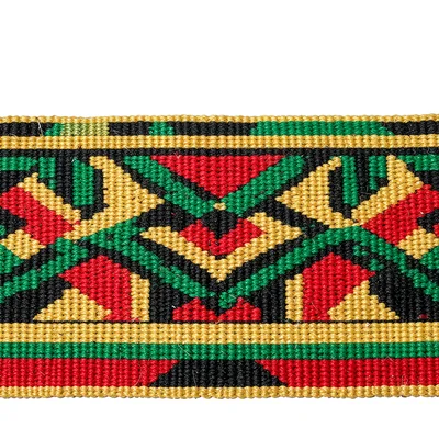 Close-up of woven kente strip — geometric motifs in gold, green, red, and black 