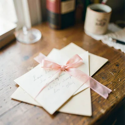 Love letters tied with ribbon on wooden desk