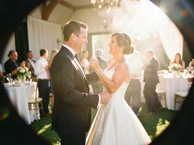 Light leak destroying half the frame where a couple slow dances at a wedding, th