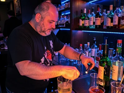 Bartender mixing in colored light