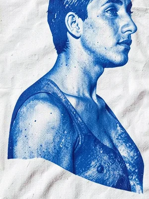 A shoulder and neck pressed onto fabric — blue body silhouette, partial face at 