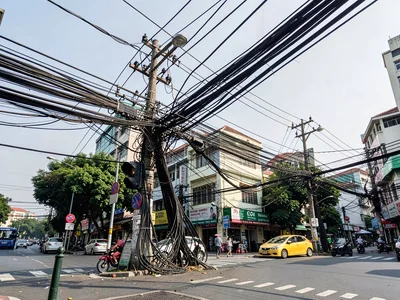 Bangkok power lines at intersection, hundreds of cables tangled and looped