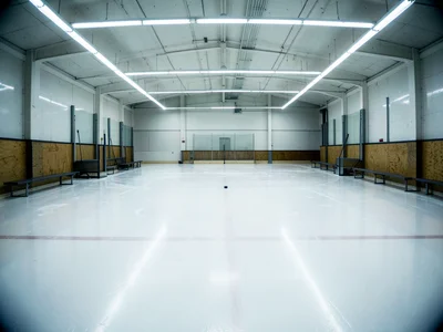 The interior of an empty ice rink after the Zamboni has made its final pass, the
