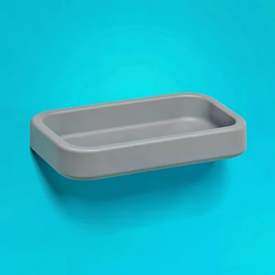 single matte-grey shower-shelf in moulded silicone top-down on a vivid teal back
