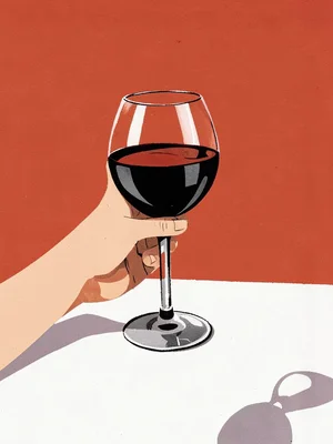 Hand holding a glass of wine, tablecloth in flat white, background warm red