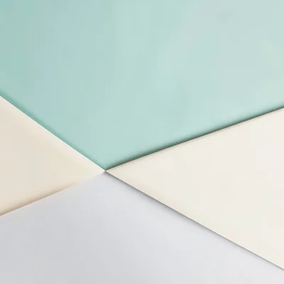 Geometric vector wave folding across a banner-wide field, alternating mint and c