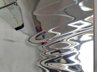 Silver mirror showing rippled image