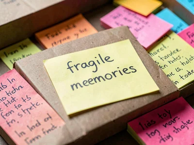 Moving box labeled with sticky note: "fragile memories," the packing poetry