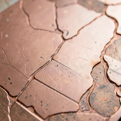 Mineral-cut close-up of a copper etching plate with acid-bitten lines