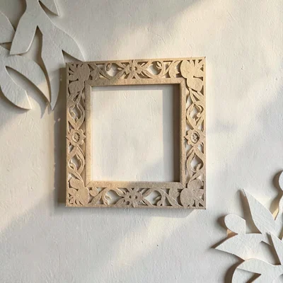 Papercraft ig-tile of a paper-cut frame on a paper-cut wall, soft warm shadows