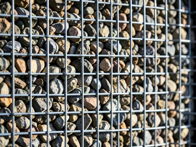 Gabion wall wire mesh filled with river stones, industrial basket weave containi