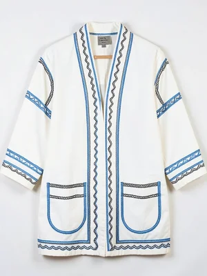 Complete Ainu coat hung flat — full garment showing all embroidery bands front v