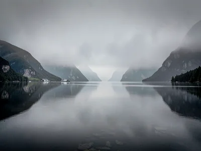 Perfect stillness on fjord surface reflecting gray