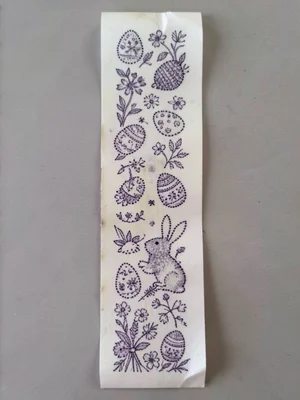 A long receipt printed with a continuous Easter scene — the thermal dots forming