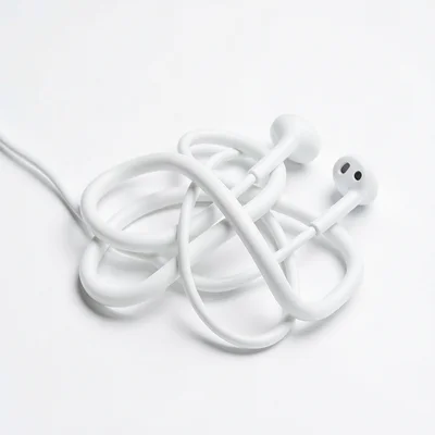 Impossibly tangled white earbuds on white background, knot lit like abstract scu