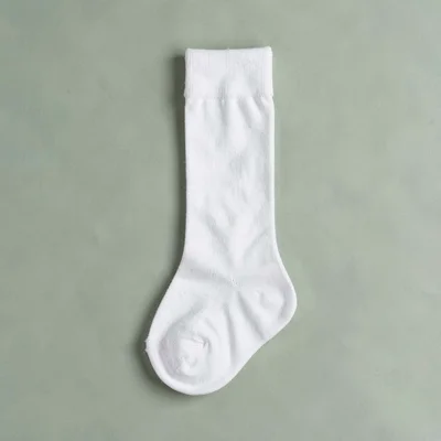 Catalog square of a draped stocking against a sage green color block, balanced n