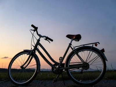 Bicycle parked against twilight gradient