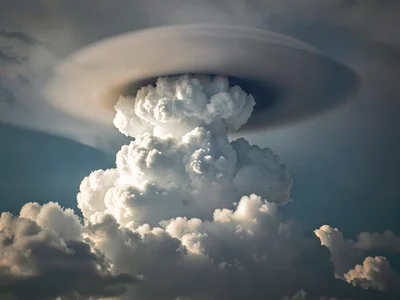Pileus cap forming over rapidly rising cumulus tower