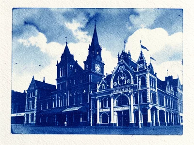 Cyanotype of city buildings decorated for pride, deep blue and white silhouettes