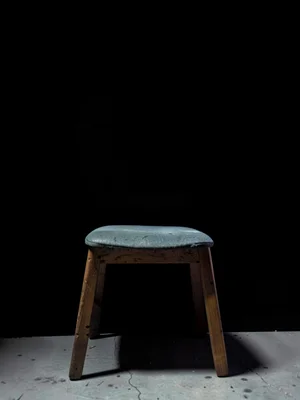 Chair at bottom edge with only legs and partial seat visible