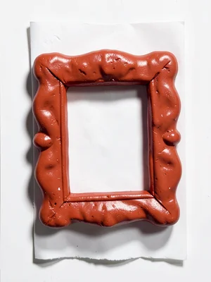 Ornate chunky clay picture frame in cherry red with stubby cream-toned matte and