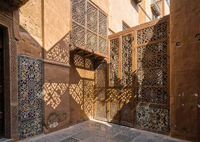 Geometric shadow play in Marrakech medina, intricate wooden mashrabiya screen ca