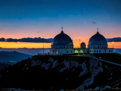 Multiple domes on hilltop against layered sunset