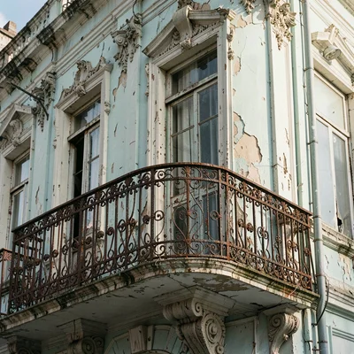 Buenos Aires faded grandeur, belle époque decay, A wrought-iron balcony with rus
