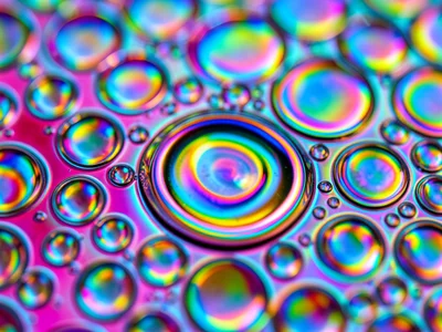 Extreme closeup of single oil bubble edge on water, interference thin-film rainb