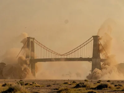 Bridge emerging from and disappearing into dust on both ends