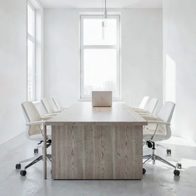 Clean-white agency studio interior with a long oak conference table and a single