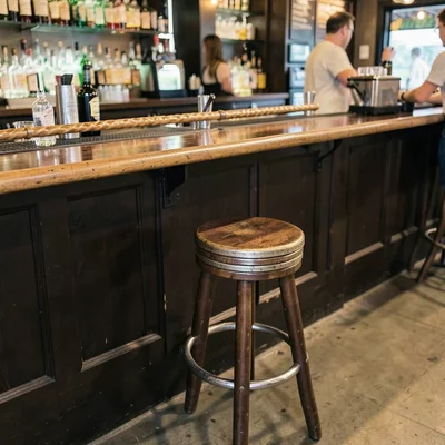 Coin stack as bar stool at bottle cap bar, pretzel stick railing