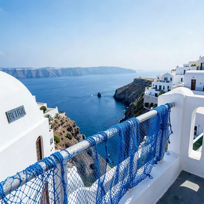 Sidi Bou Said cobalt-white, cliff-top absolute palette, Blue fishing nets draped