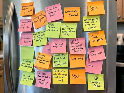 Fridge door covered in family sticky notes, the communication center, grocery li