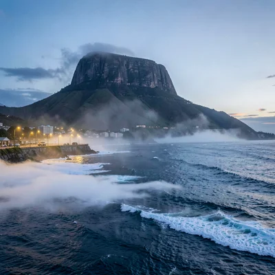 Cape Town mountain-sea duality, Table Mountain backdrop, evening fog rolling in 