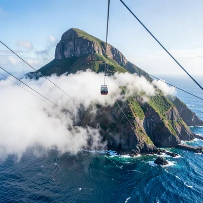 Cape Town mountain-sea duality, Table Mountain backdrop, cable car ascending thr